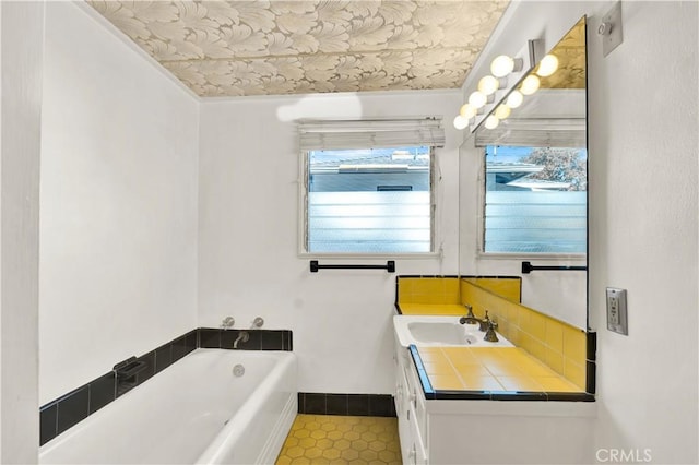 bathroom featuring a tub to relax in and vanity