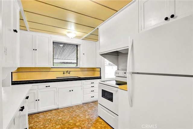 kitchen with white cabinetry, sink, and white appliances