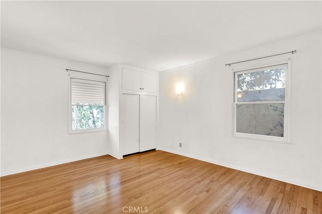 unfurnished room with light hardwood / wood-style floors