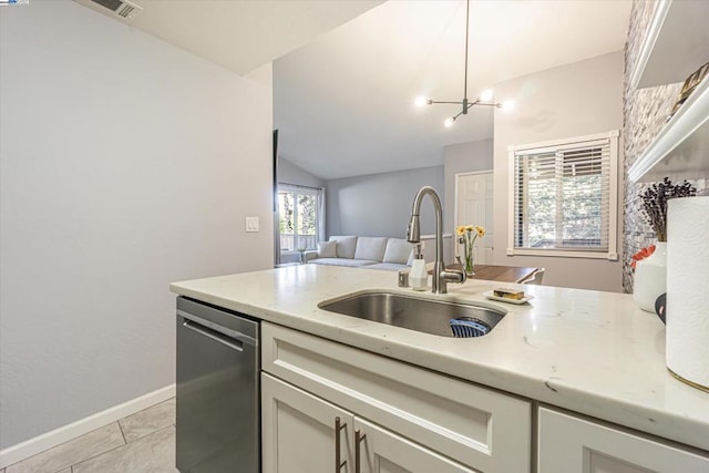 kitchen featuring sink, decorative light fixtures, vaulted ceiling, light tile patterned flooring, and stainless steel dishwasher