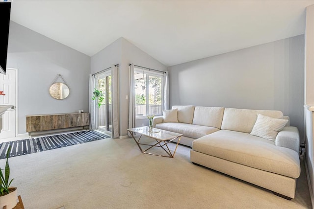 carpeted living room with lofted ceiling