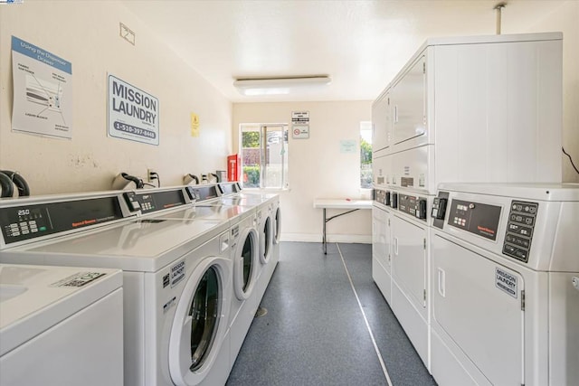 clothes washing area with stacked washing maching and dryer and washing machine and dryer