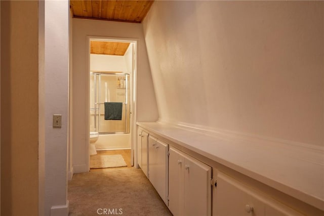 hall with wood ceiling and light carpet