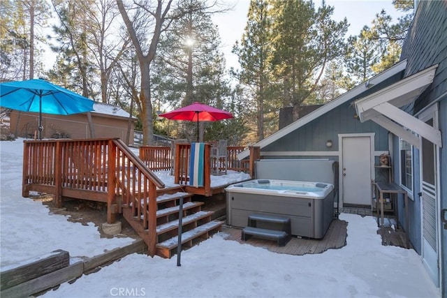 snow covered deck featuring a hot tub