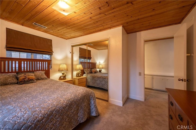 bedroom with a closet, wooden ceiling, and light carpet