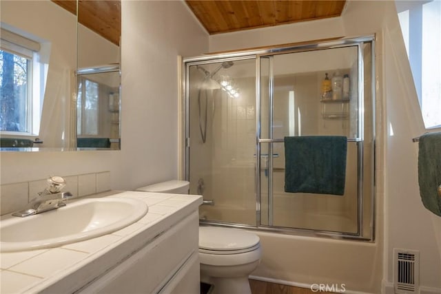 full bathroom with wood ceiling, toilet, vanity, bath / shower combo with glass door, and lofted ceiling