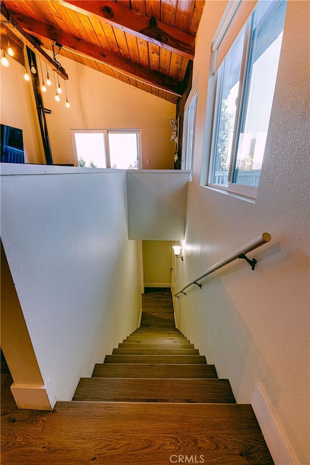 stairs featuring beam ceiling and wood ceiling