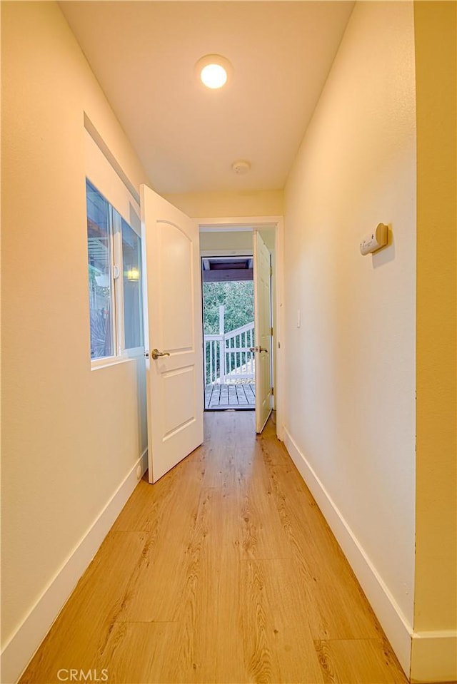 hallway with light hardwood / wood-style floors