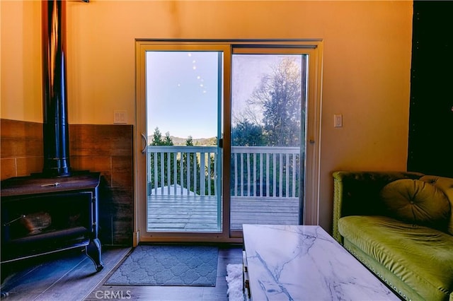 doorway to outside with a wood stove