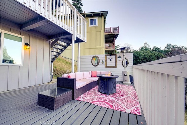 wooden deck with an outdoor living space with a fire pit