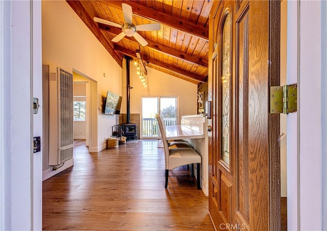 hallway with vaulted ceiling with beams, hardwood / wood-style flooring, and wooden ceiling