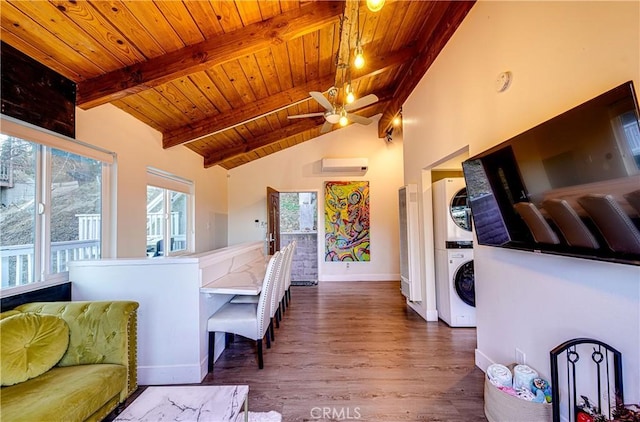 kitchen with vaulted ceiling with beams, a wall mounted air conditioner, stacked washing maching and dryer, dark wood-type flooring, and wooden ceiling