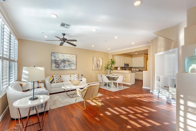 living room featuring ceiling fan and wood-type flooring