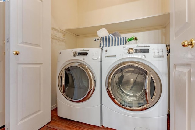 washroom featuring hardwood / wood-style flooring and independent washer and dryer