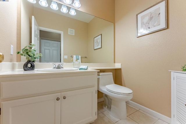 bathroom with tile patterned flooring, vanity, and toilet