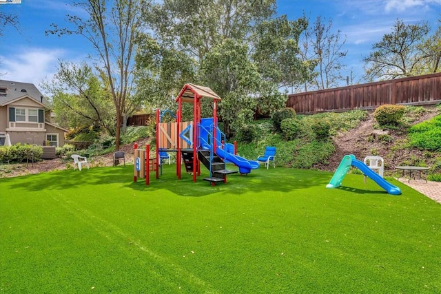 view of playground with a lawn