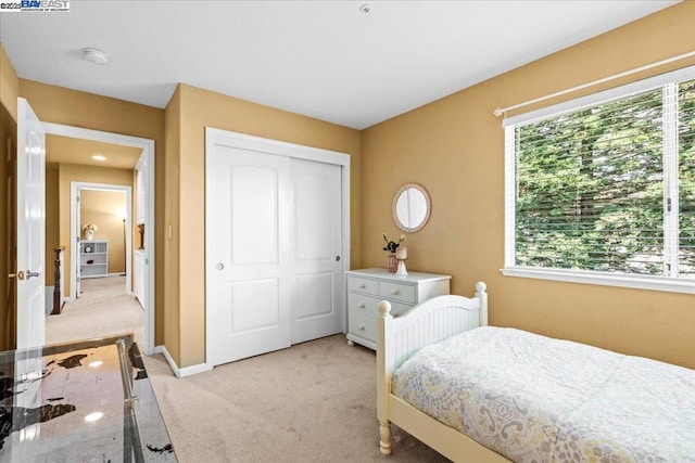 carpeted bedroom featuring a closet