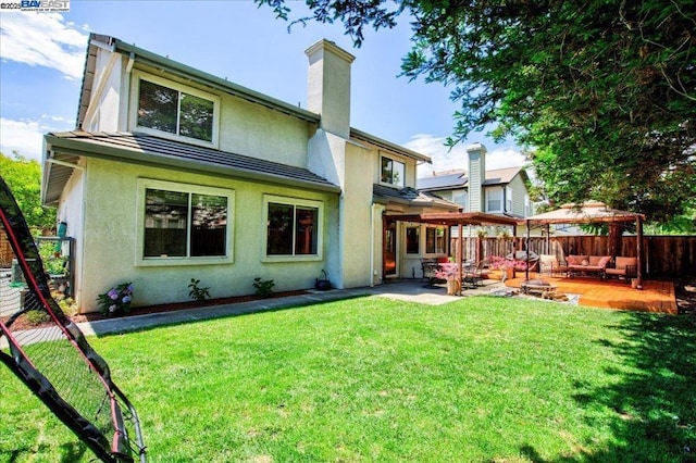 back of house featuring a lawn, a gazebo, and a patio area