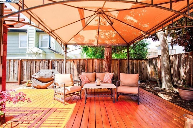 wooden terrace featuring an outdoor living space and a gazebo