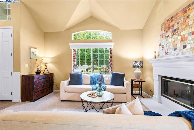 living room with light colored carpet and vaulted ceiling