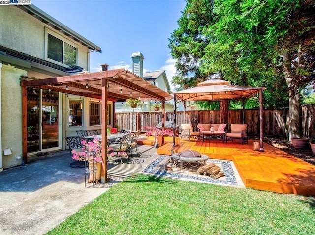 view of yard featuring an outdoor living space with a fire pit, a patio area, and a gazebo