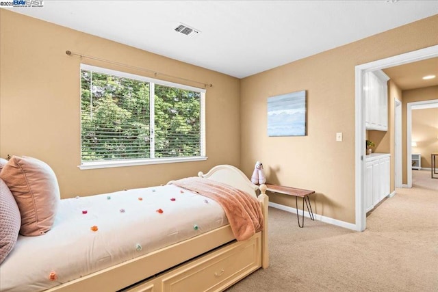 bedroom featuring light carpet