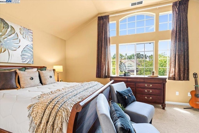 bedroom with vaulted ceiling and light colored carpet