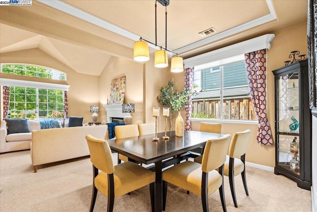 dining space featuring lofted ceiling and light colored carpet