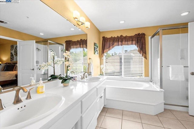 bathroom featuring independent shower and bath, tile patterned flooring, and vanity