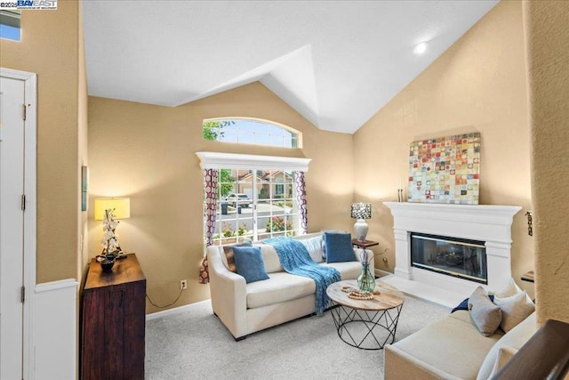 carpeted living room featuring lofted ceiling