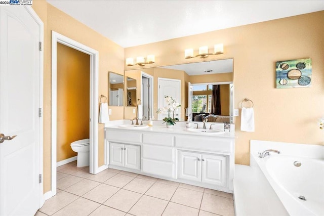 bathroom featuring toilet, a washtub, tile patterned flooring, and vanity