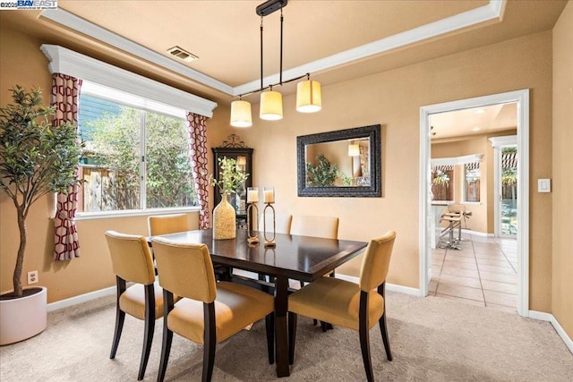 dining space featuring light colored carpet