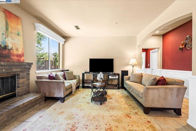 living room featuring a brick fireplace