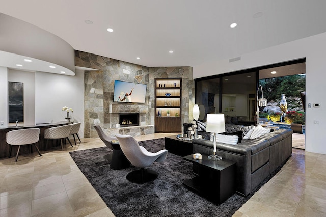 living room with a stone fireplace