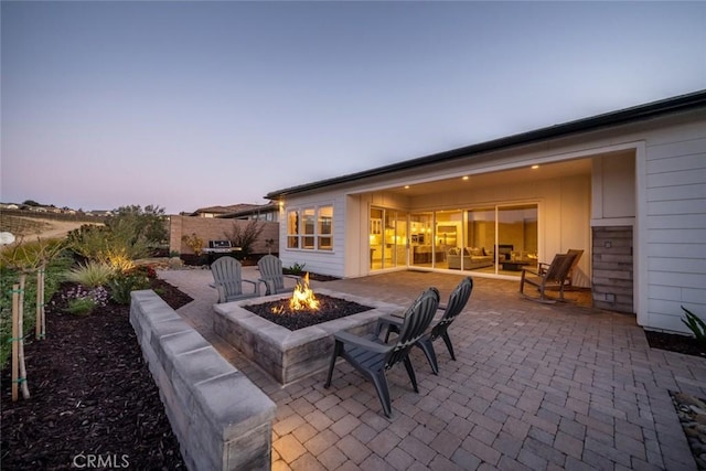 patio terrace at dusk with a fire pit