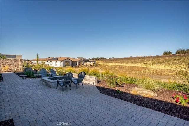 view of patio with a fire pit