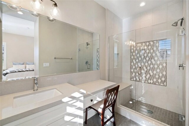 bathroom with walk in shower and vanity