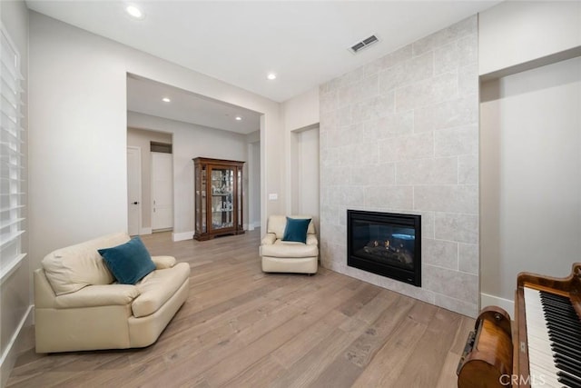 living room featuring a fireplace and light hardwood / wood-style flooring