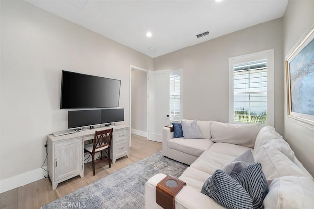 living room with light hardwood / wood-style flooring