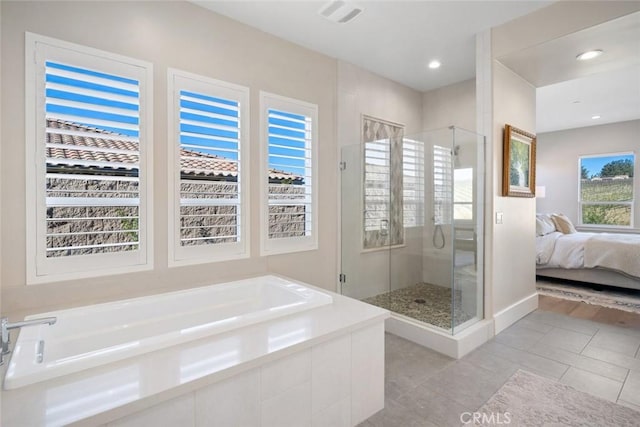 bathroom featuring a healthy amount of sunlight, separate shower and tub, and tile patterned floors