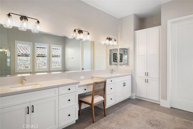 bathroom with tile patterned flooring, a shower with shower door, and vanity