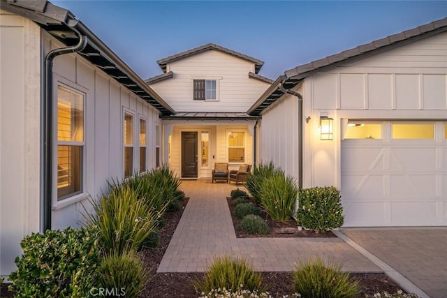 exterior entry at dusk with a garage