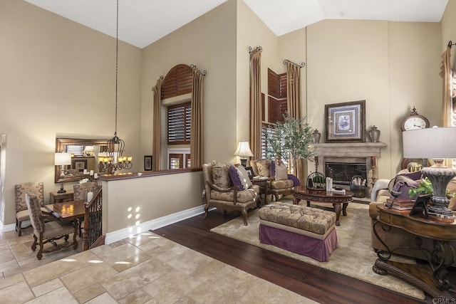 sitting room with vaulted ceiling and a chandelier