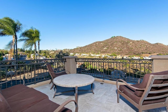 view of patio / terrace with a balcony and a mountain view