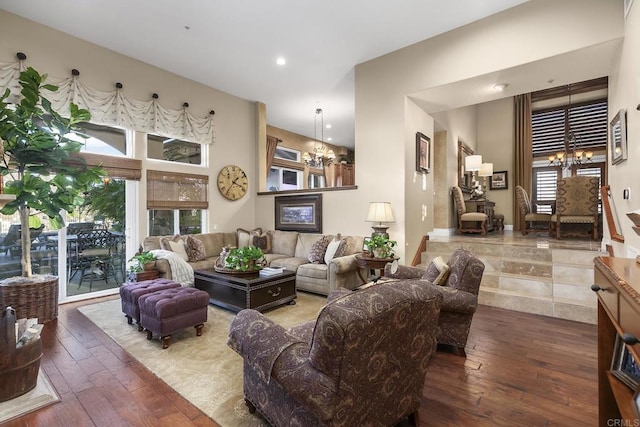 living room featuring recessed lighting, an inviting chandelier, and hardwood / wood-style flooring