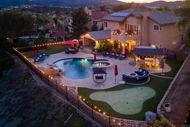 view of pool featuring a fenced in pool, an in ground hot tub, outdoor dry bar, and a patio area