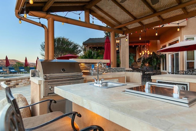 view of patio / terrace with a sink, grilling area, area for grilling, and outdoor wet bar