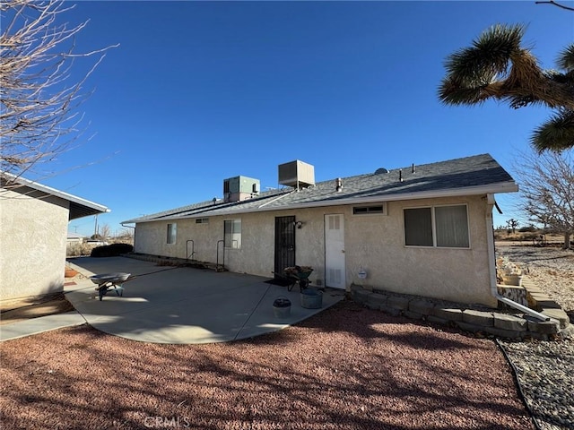 back of property featuring central air condition unit, a patio area, and stucco siding