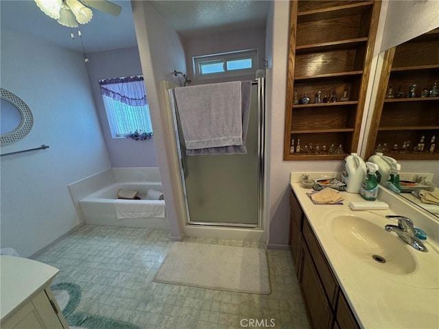 bathroom featuring baseboards, a wealth of natural light, vanity, and a stall shower