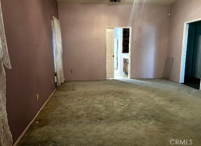 unfurnished room with visible vents and carpet